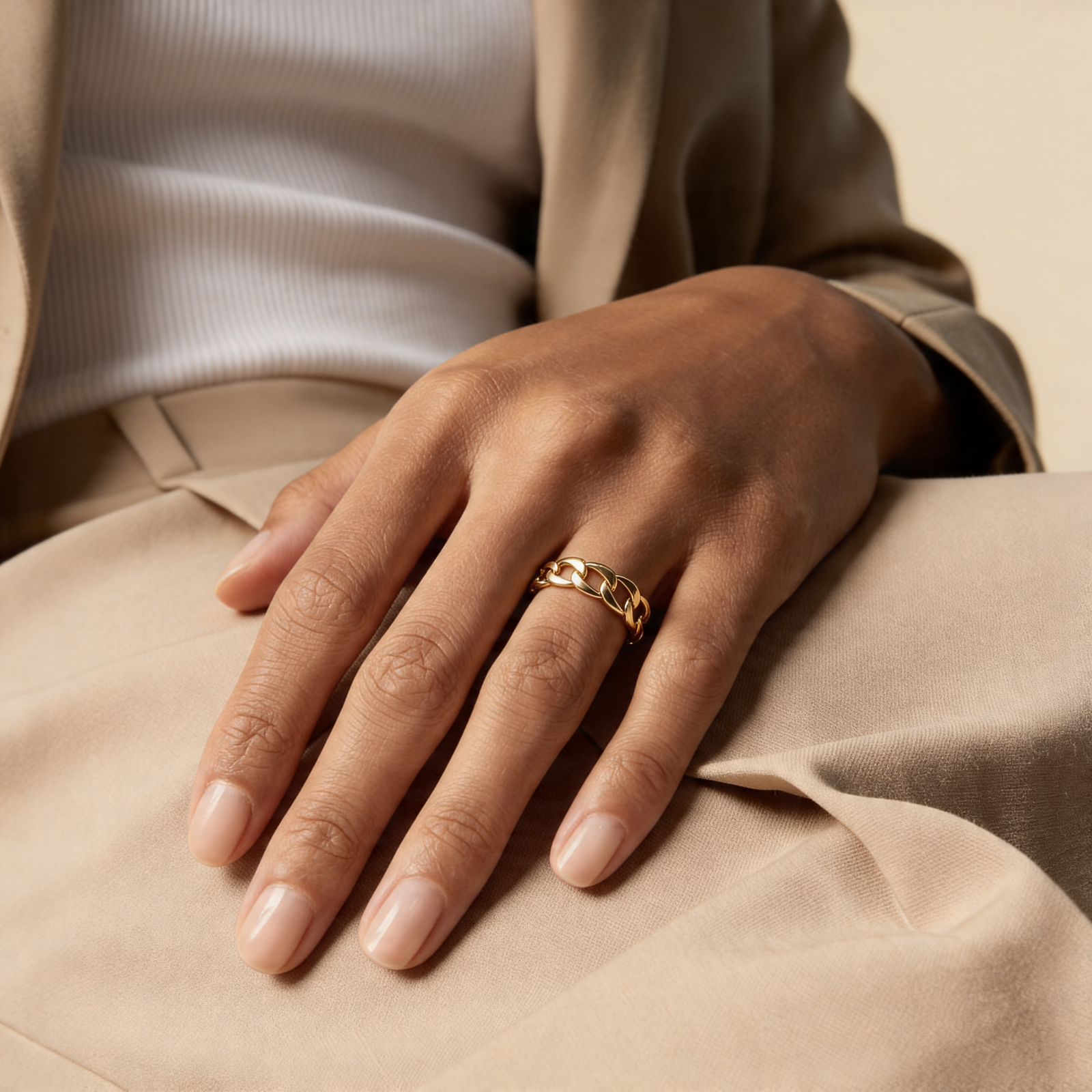 18k gold thin chain rings and twisted rings for women on light pink fabric