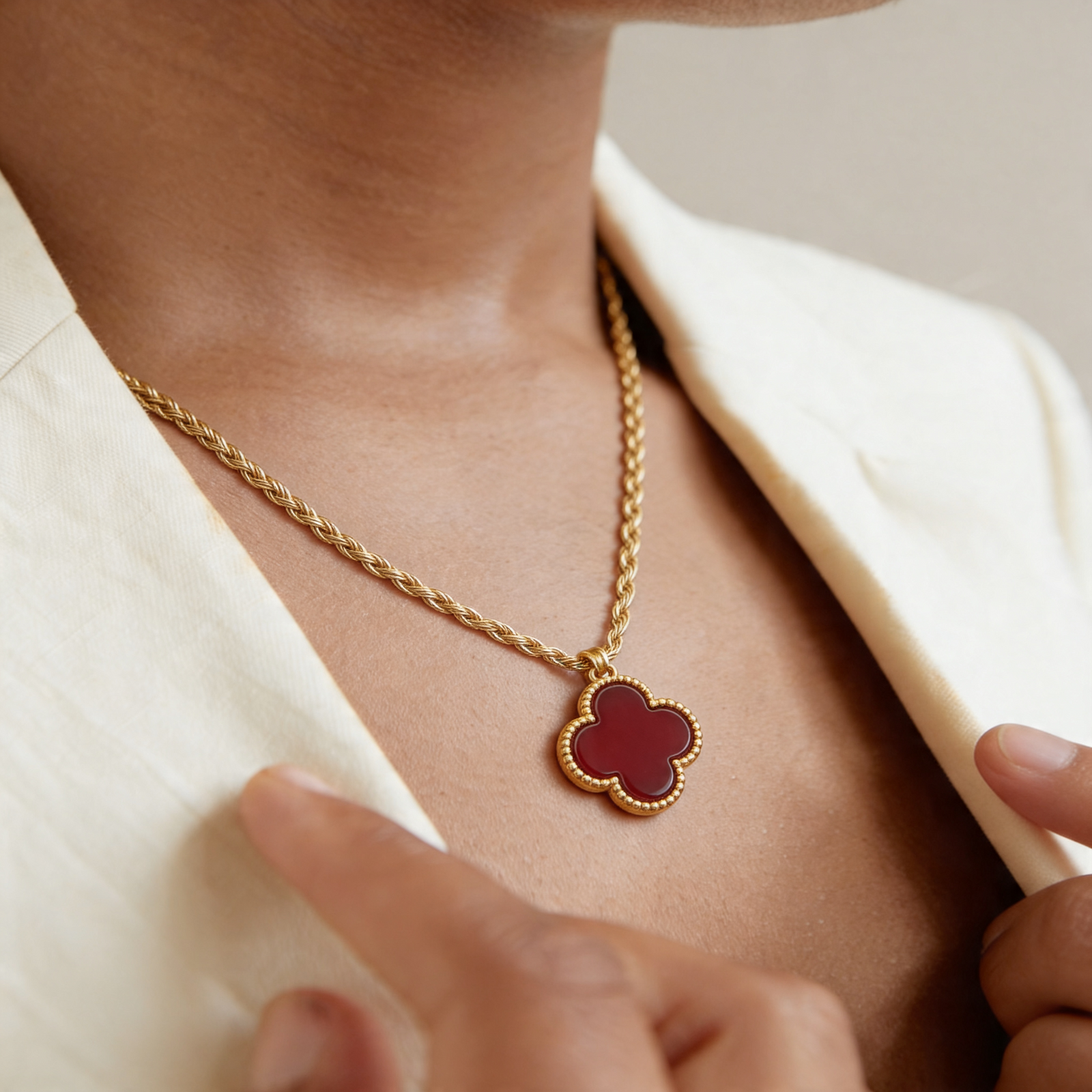 18k gold Allah necklace with light chain on soft pink fabric background