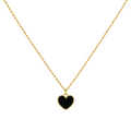 Gold necklace with a black heart pendant on a white background