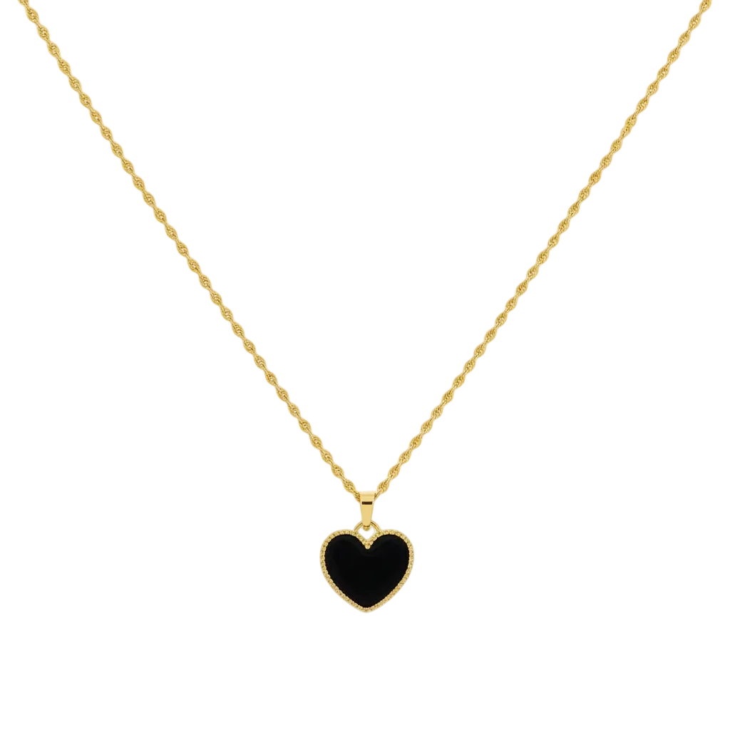 Gold necklace with a black heart pendant on a white background