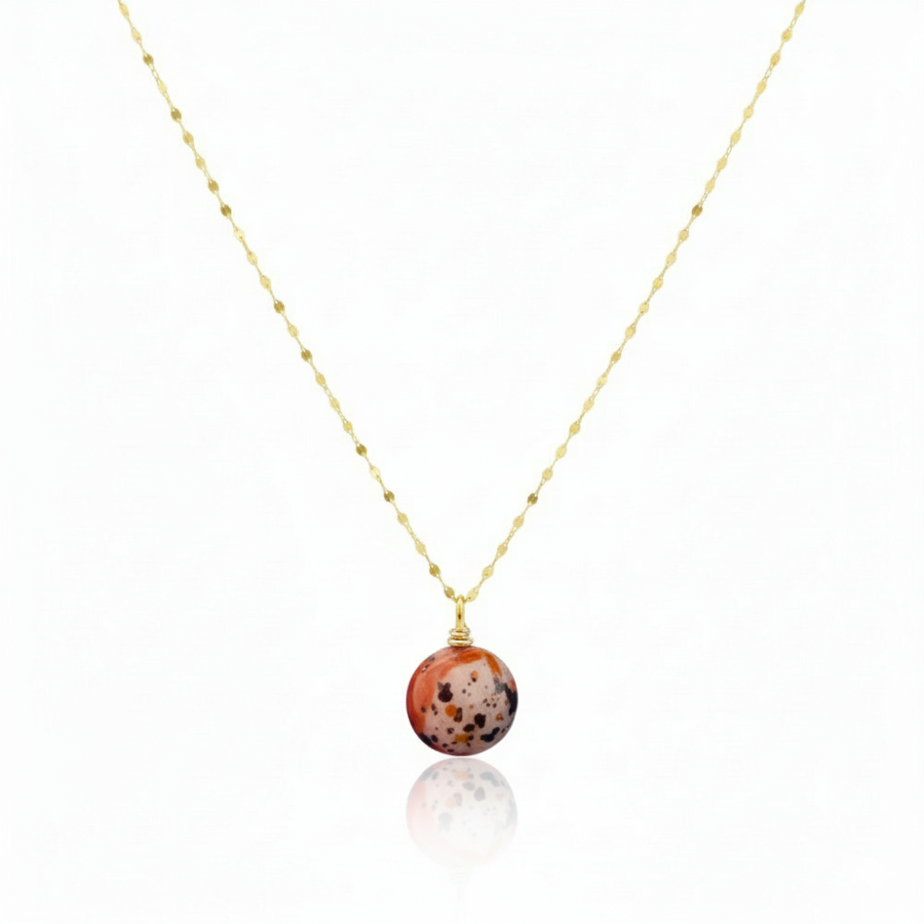 Necklace with a round, multicolored pendant on a thin chain against a white background