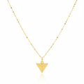 Gold triangle pendant necklace on a white background
