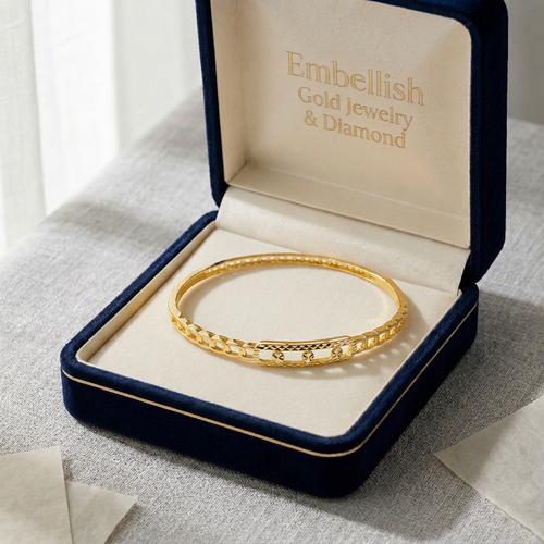 Gold bracelet in a 'Embellish Gold Jewelry & Diamond' box on a light background