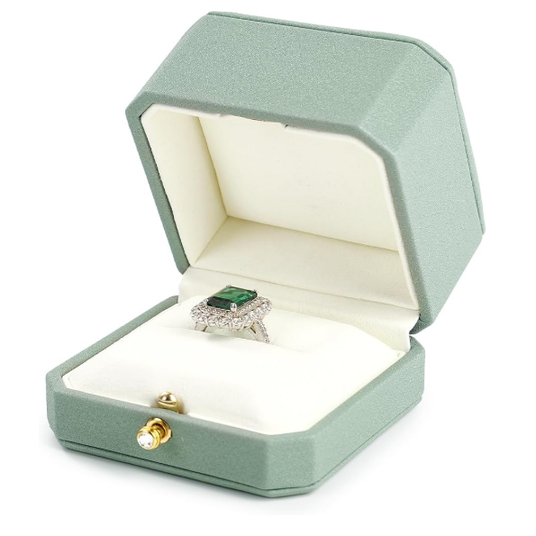 Open light green jewelry box with a ring inside on a white background