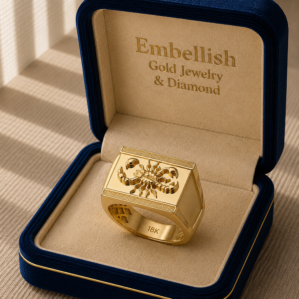Gold ring with intricate design in a 'Embellish Gold Jewelry & Diamond' box.