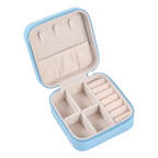 Open jewelry case with compartments on a light gray background