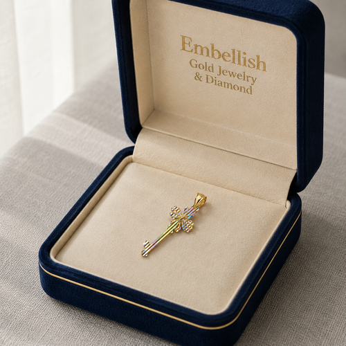 Gold jewelry pendant in an open 'Embellish Gold Jewelry & Diamond' box on a neutral background