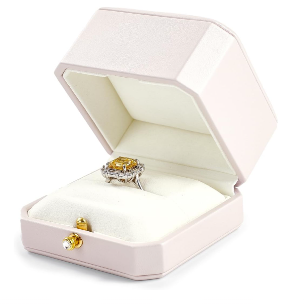Open jewelry box with a ring and earrings on a white background