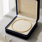 Gold necklace in an open jewelry box with 'Embellish Gold Jewelry & Diamond' branding.