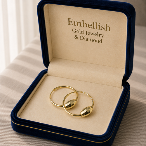 Gold jewelry in a 'Embellish Gold Jewelry & Diamond' box on a neutral background