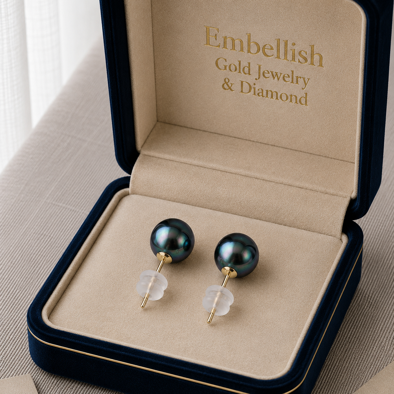 Pair of black pearl earrings in a 'Embellish Gold Jewelry & Diamond' box.
