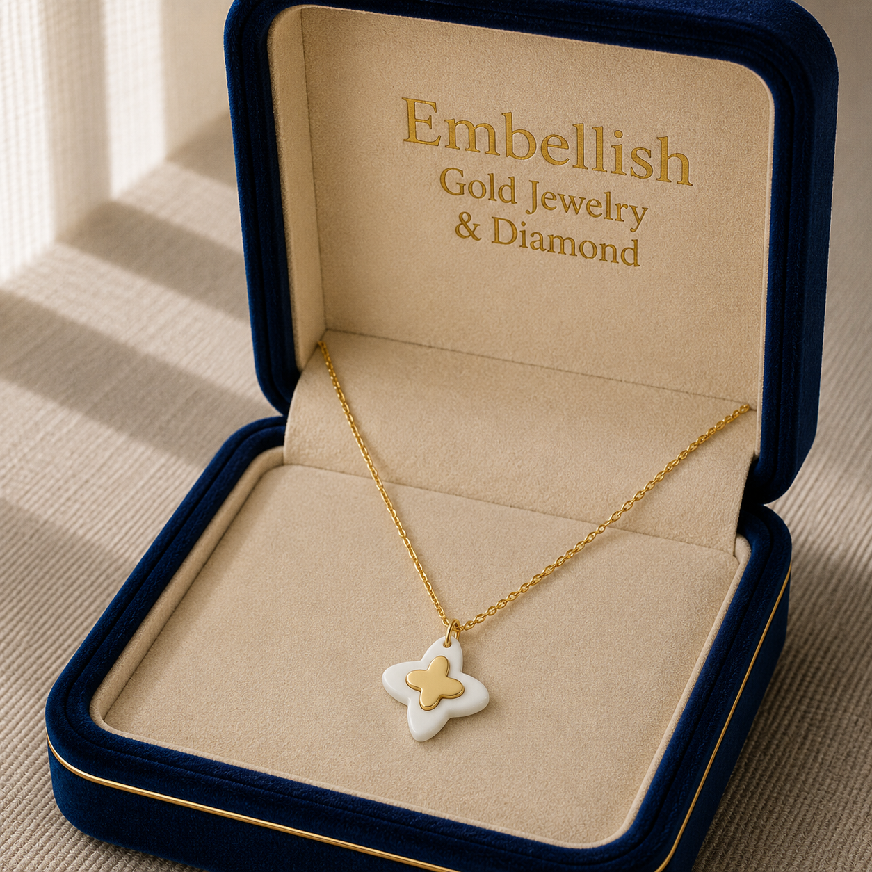 Gold necklace with a star-shaped pendant in an 'Embellish' jewelry box.
