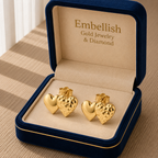 Gold heart-shaped earrings in a 'Embellish' jewelry box on a wooden surface.