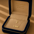 Gold necklace with heart pendants in a 'Embellish Gold Jewelry & Diamond' box.