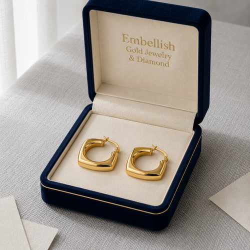 Gold hoop earrings in a 'Embellish Gold Jewelry & Diamond' box on a light gray surface.