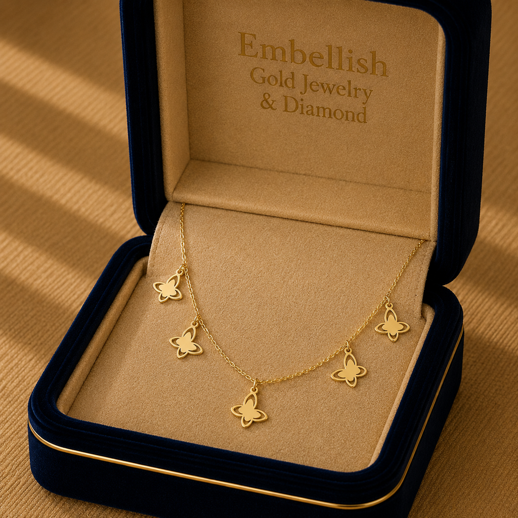 Gold butterfly necklace in an 'Embellish Gold Jewelry & Diamond' box on a beige background