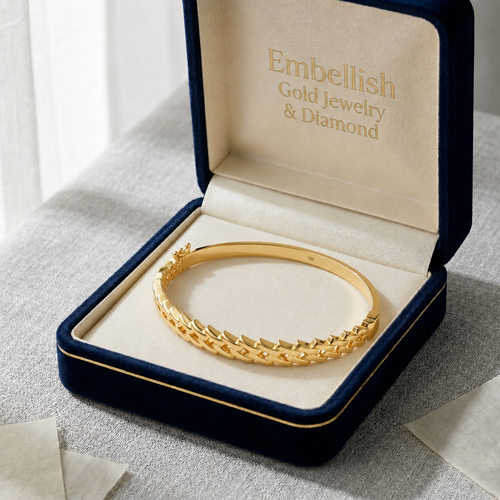 Gold bracelet in a 'Embellish Gold Jewelry & Diamond' box on a light background