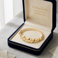Gold bracelet in an open jewelry box with 'Embellish Gold Jewelry & Diamond' branding.