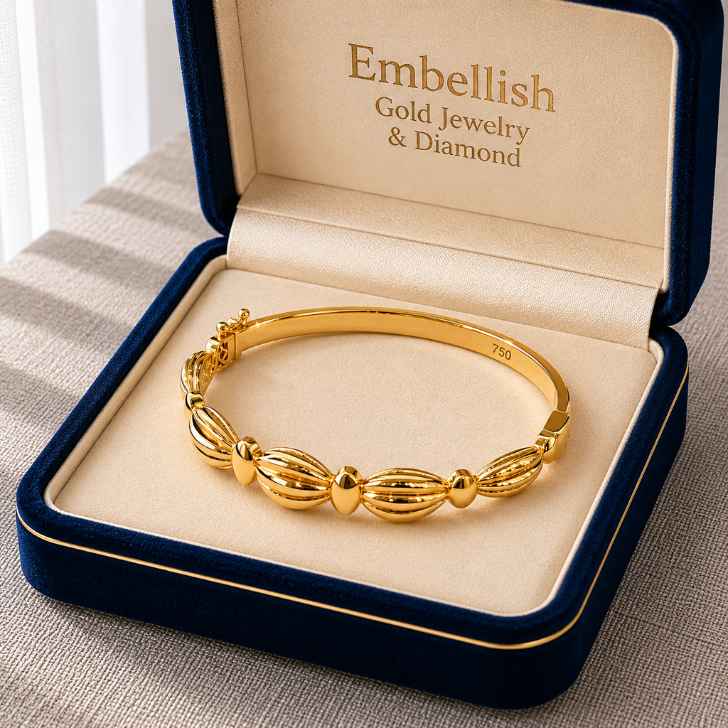 Gold bracelet in a 'Embellish Gold Jewelry & Diamond' box on a textured surface.