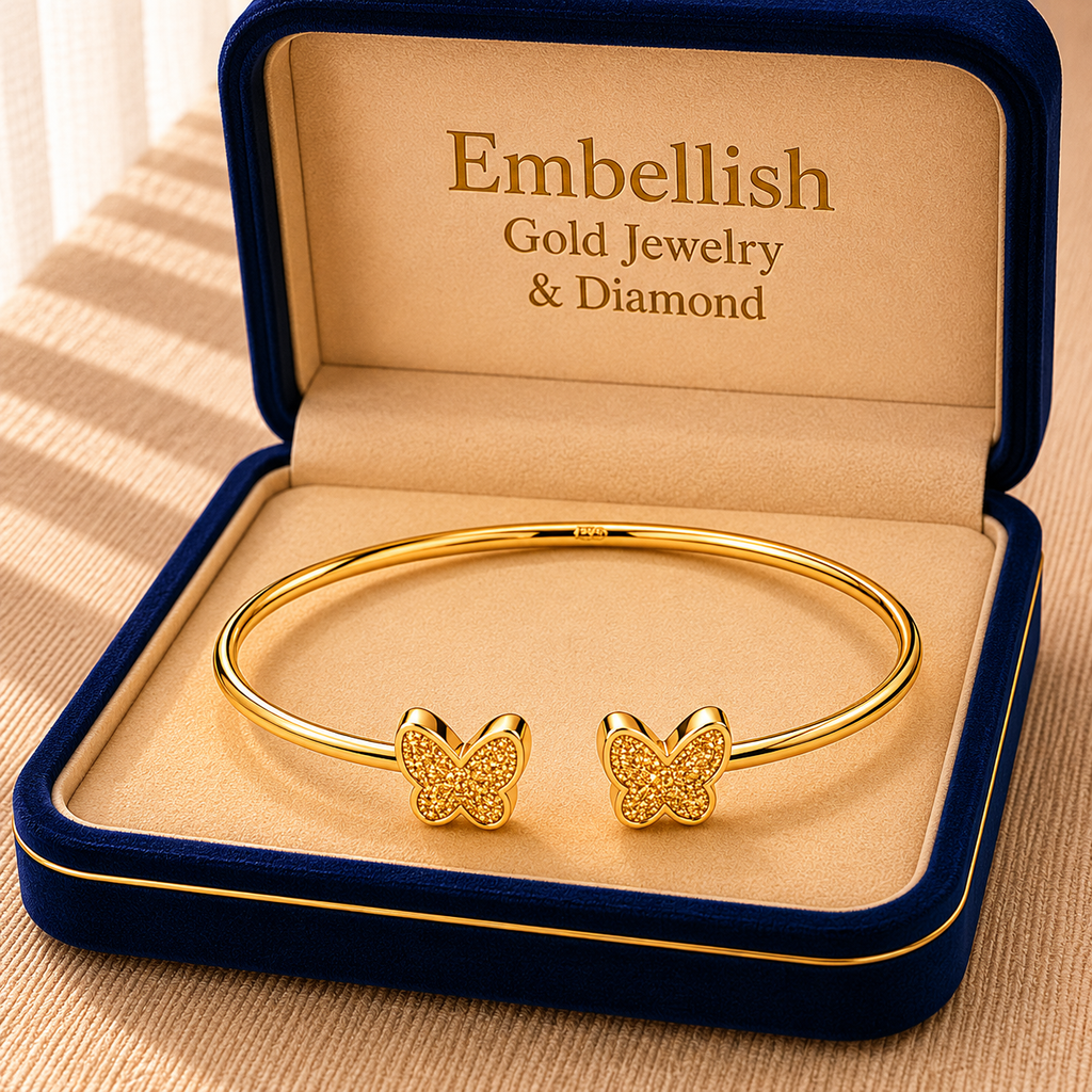 Gold bracelet with butterfly charms in an 'Embellish' jewelry box.
