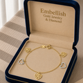 Gold bracelet with heart charms in a 'Embellish Gold Jewelry & Diamond' box.