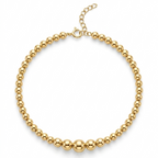 Gold beaded necklace on a white background