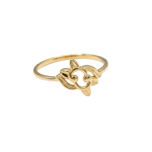 Gold ring with a floral design on a white background