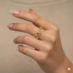 Gold ring on a hand against a beige background