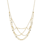 Two gold necklaces on a light gray background
