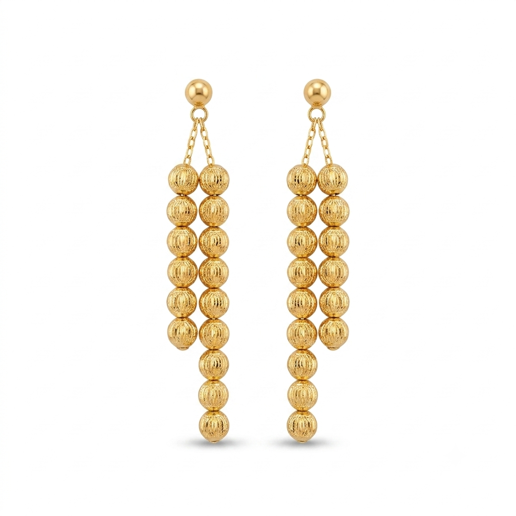A pair of gold dangle earrings with textured spherical beads, shown against a plain white background.