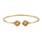 Gold bracelet with knot design on a white background