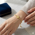 Gold bracelet on a wrist with a neutral background
