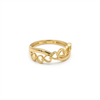 Gold ring with intricate design on a white background
