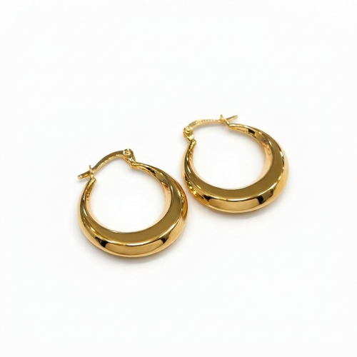 Gold hoop earrings on a white background