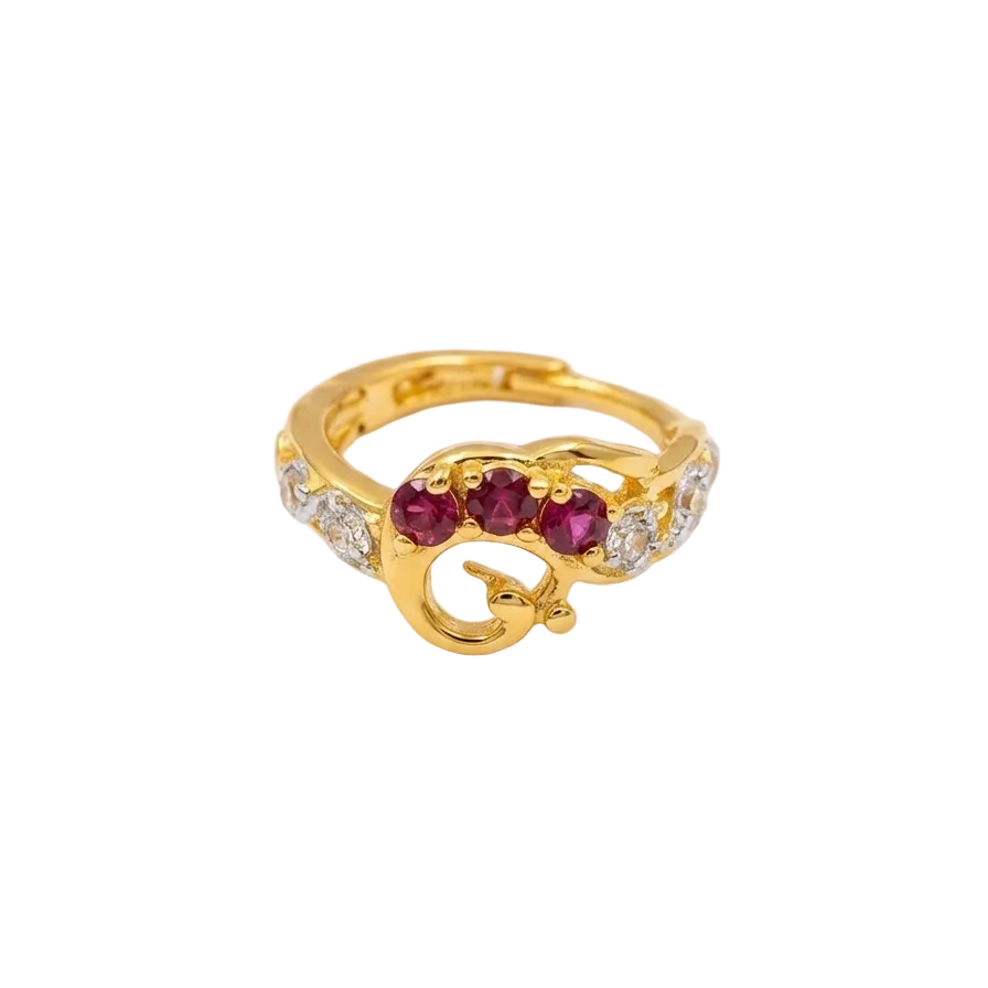 Gold ring with red gemstones and diamonds on a white background