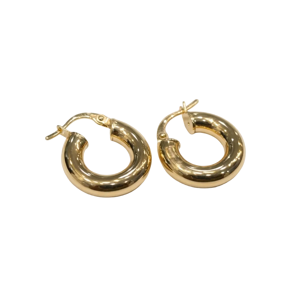 Gold hoop earrings on a white surface