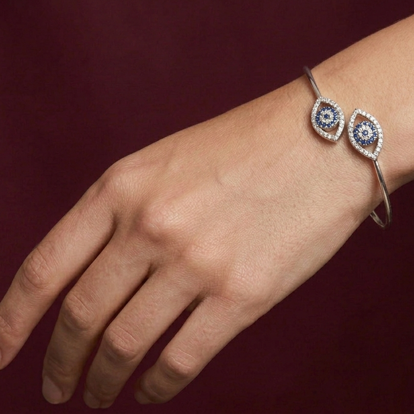 Jewelry bracelet on a wrist against a dark red background