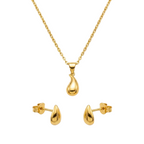 Gold necklace and earrings set on a white background