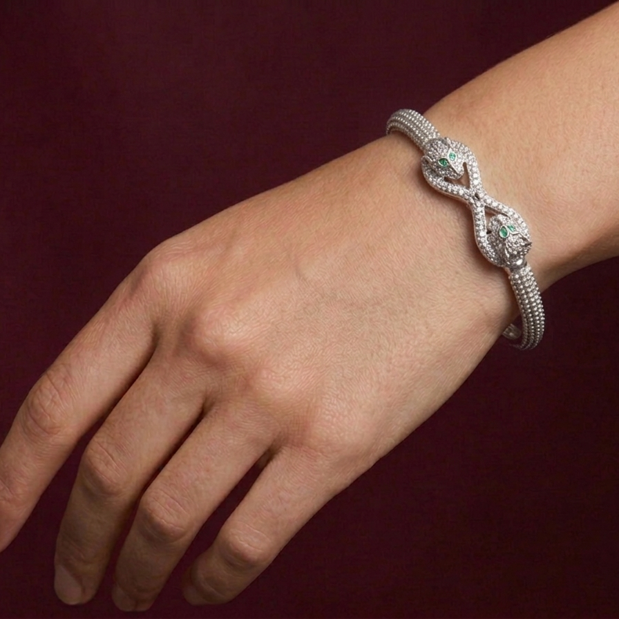 Silver bracelet on a wrist against a dark background