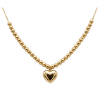 Gold necklace with a heart pendant on a mannequin bust.
