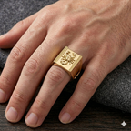 Gold ring on a person's finger with a textured design, set against a dark background.