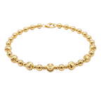 Gold beaded bracelet on a white background