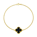 Gold bracelet with a black clover-shaped charm on a white background