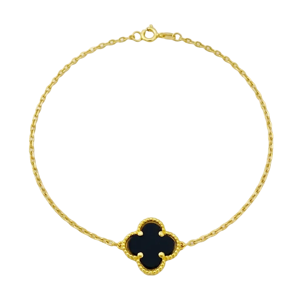 Gold bracelet with a black clover-shaped charm on a white background