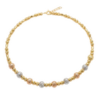Gold, rose gold, and silver beaded necklace on a white background