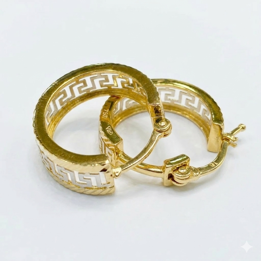 Gold hoop earrings with intricate design on a white background