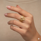 Hand wearing a gold ring with star designs on a beige background