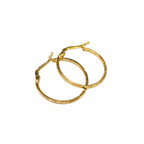 Gold hoop earrings on a light gray background