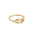 Gold ring with a bow design on a white background
