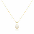 Gold necklace with a single pearl pendant on a white background
